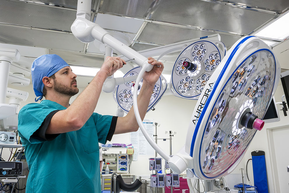 Image of technician working on a surgery light in a hospital